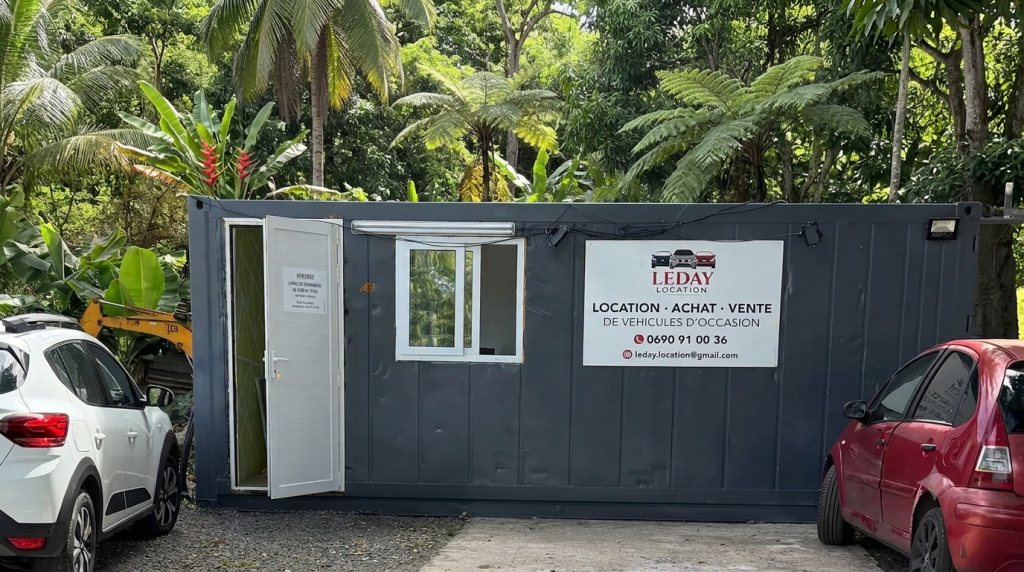 L'agence Leday Location à Vieux-Habitants, avec deux véhicules garés devant